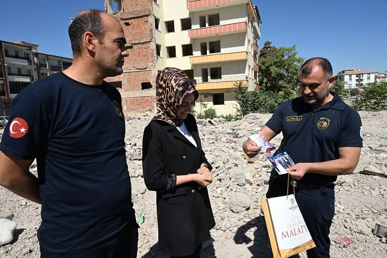 6 Şubat’ta yaşanan deprem sonrasında yıkılan Bayrak Apartmanı’nın enkazında buldukları özel eşyaları, sahibine teslim ettiler.